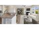 Open-concept living room flows from kitchen with fireplace, modern shelving, and sleek furnishings at 1019 Thoughtful Spot Ln, Durham, NC 27703