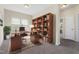 Inviting office with a built-in bookshelf, large window, and comfortable furnishings at 1019 Thoughtful Spot Ln, Durham, NC 27703