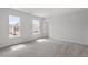 This bedroom has carpet and two windows at 104 Black Walnut Dr # 202, Garner, NC 27529