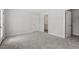This bedroom has carpet, a door to the bathroom, and a closet at 104 Black Walnut Dr # 202, Garner, NC 27529