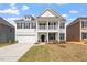 Charming two-story home features a welcoming front porch and a two-car garage at 104 Black Walnut Dr # 202, Garner, NC 27529