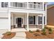 Inviting front porch featuring white columns, brick accents, and a well-maintained landscape at 104 Black Walnut Dr # 202, Garner, NC 27529
