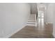 Bright hallway features hardwood floors, a staircase, and neutral paint tones at 104 Black Walnut Dr # 202, Garner, NC 27529