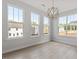 Open concept living room features lots of natural light and modern chandelier at 104 Black Walnut Dr # 202, Garner, NC 27529