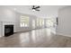 Open concept living room features a fireplace, modern chandelier and lots of natural light at 104 Black Walnut Dr # 202, Garner, NC 27529