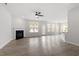 Bright, open living room with fireplace, modern ceiling fan and large windows offering plenty of natural light at 104 Black Walnut Dr # 202, Garner, NC 27529