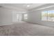 Spacious main bedroom with plush carpet, large windows, and ample space for relaxation and rest at 104 Black Walnut Dr # 202, Garner, NC 27529