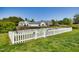 Community dog park with a white picket fence, shade trees, and convenient parking at 1064 Blue Bird Ln, Wake Forest, NC 27587