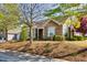 Charming home featuring stone and siding exterior with manicured landscaping and mature trees at 1064 Blue Bird Ln, Wake Forest, NC 27587