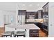 Modern kitchen featuring dark cabinetry, a granite countertop island, and stainless steel appliances at 1064 Blue Bird Ln, Wake Forest, NC 27587