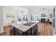 Open concept kitchen with granite island overlooking the dining and living spaces, creating an inviting atmosphere at 1064 Blue Bird Ln, Wake Forest, NC 27587