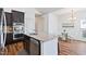 Well-equipped kitchen boasts stainless steel appliances, granite countertops, and convenient access to the dining area at 1064 Blue Bird Ln, Wake Forest, NC 27587