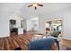 Bright living area with dark wood floors, featuring views into the kitchen and access to an outdoor patio at 1064 Blue Bird Ln, Wake Forest, NC 27587