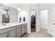 This primary bathroom includes dual sinks, quartz counters, and a view into the walk-in closet at 124 Alta Crest Ln, Garner, NC 27529
