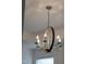 A modern, rustic, dark wood chandelier with candelabra bulbs hangs from the ceiling at 124 Alta Crest Ln, Garner, NC 27529
