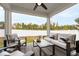 Relaxing covered patio featuring stylish outdoor seating, ceiling fan, and a view of the expansive backyard at 124 Alta Crest Ln, Garner, NC 27529