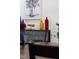 Close up on decorated shelving unit with colored bottles and decorative plants and an art painting on the wall at 124 Alta Crest Ln, Garner, NC 27529