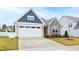 Charming exterior with a two-car garage, stone accents, and well-maintained landscaping at 124 Alta Crest Ln, Garner, NC 27529