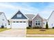 Charming single-Gathering home featuring stone accents, a two-car garage, and a well-manicured lawn at 124 Alta Crest Ln, Garner, NC 27529