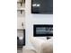 Detail of a modern fireplace, built-in shelves, and entertainment center in the living room at 124 Alta Crest Ln, Garner, NC 27529