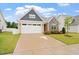 Inviting home with a manicured lawn and a two-car garage, showcasing great curb appeal at 124 Alta Crest Ln, Garner, NC 27529