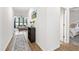 Hallway view, leading to a bright living room and bedroom with neutral color palette and hardwood flooring at 124 Alta Crest Ln, Garner, NC 27529
