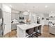 Modern kitchen with gray cabinets, stainless steel appliances, quartz countertops, island, and pendant lights at 124 Alta Crest Ln, Garner, NC 27529