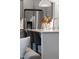 Modern kitchen island with seating, stainless steel refrigerator, and quartz countertops at 124 Alta Crest Ln, Garner, NC 27529