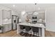 Modern kitchen with gray cabinets, stainless steel appliances, quartz countertops, island, and pendant lights at 124 Alta Crest Ln, Garner, NC 27529