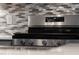 Stainless steel oven with a tile backsplash in a kitchen with quartz countertops at 124 Alta Crest Ln, Garner, NC 27529