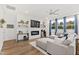 Spacious living room featuring hardwood floors, a modern fireplace, and a comfortable sectional sofa at 124 Alta Crest Ln, Garner, NC 27529