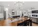 Open living space with modern kitchen, dining area, and living room with fireplace and chandelier lighting at 124 Alta Crest Ln, Garner, NC 27529