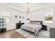 Large main bedroom with luxury gray carpet, dark wood furniture, tray ceiling, and chandelier lighting at 124 Alta Crest Ln, Garner, NC 27529