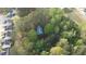 Aerial view of a secluded home surrounded by lush greenery and mature trees at 1355 Bowling Road, Fuquay Varina, NC 27526