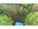 Aerial view of the house showing the metal roof surrounded by lush greenery and mature trees at 1355 Bowling Road, Fuquay Varina, NC 27526