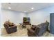 Basement living area with comfortable seating and recessed lighting is ideal for relaxing at 1355 Bowling Road, Fuquay Varina, NC 27526