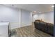 Basement area features wood-look flooring, laundry area, and comfortable seating at 1355 Bowling Road, Fuquay Varina, NC 27526