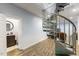 Basement landing with a spiral staircase and a bathroom with wood look flooring at 1355 Bowling Road, Fuquay Varina, NC 27526