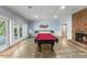 Finished basement with a red billiard table and fireplace is an entertainer's delight at 1355 Bowling Road, Fuquay Varina, NC 27526