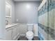 Bathroom with a white vanity, modern fixtures, and a patterned shower curtain at 1355 Bowling Road, Fuquay Varina, NC 27526