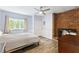 Cozy bedroom featuring a brick fireplace, wood flooring and a sunlit window at 1355 Bowling Road, Fuquay Varina, NC 27526