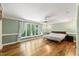 Spacious bedroom boasts large windows, hardwood floors and light green wall color at 1355 Bowling Road, Fuquay Varina, NC 27526
