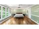 Cozy bedroom with hardwood floors, natural light, and neutral decor at 1355 Bowling Road, Fuquay Varina, NC 27526