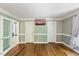 Large bedroom with hardwood floors, white molding, and a window at 1355 Bowling Road, Fuquay Varina, NC 27526