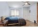 Comfortable bedroom featuring a ceiling fan, plenty of closet space, light blue walls, and wood-look flooring at 1355 Bowling Road, Fuquay Varina, NC 27526