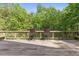 Relax on this outdoor deck overlooking lush greenery and wooded backyard at 1355 Bowling Road, Fuquay Varina, NC 27526