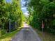 Long private driveway leading to property completely surrounded by lush greenery at 1355 Bowling Road, Fuquay Varina, NC 27526