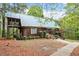Inviting exterior with rustic wood siding, metal roof, and lush landscaping at 1355 Bowling Road, Fuquay Varina, NC 27526