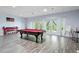 Game room featuring a pool table, ample lighting, gray floors, and access to outdoor views at 1355 Bowling Road, Fuquay Varina, NC 27526