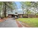 Detached wooden garage with a boat and trailer parked in front, with extra storage space on the side at 1355 Bowling Road, Fuquay Varina, NC 27526